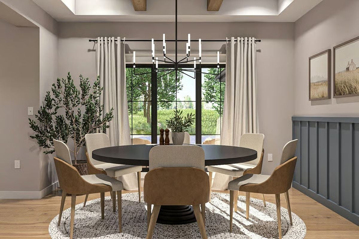 Round Table, Mixed Chairs, and a Chandelier That Doesn't Try Too Hard