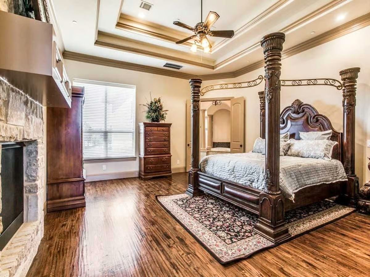 Four-Post Bed with Ironwork Canopy in a Master Suite Built to Last