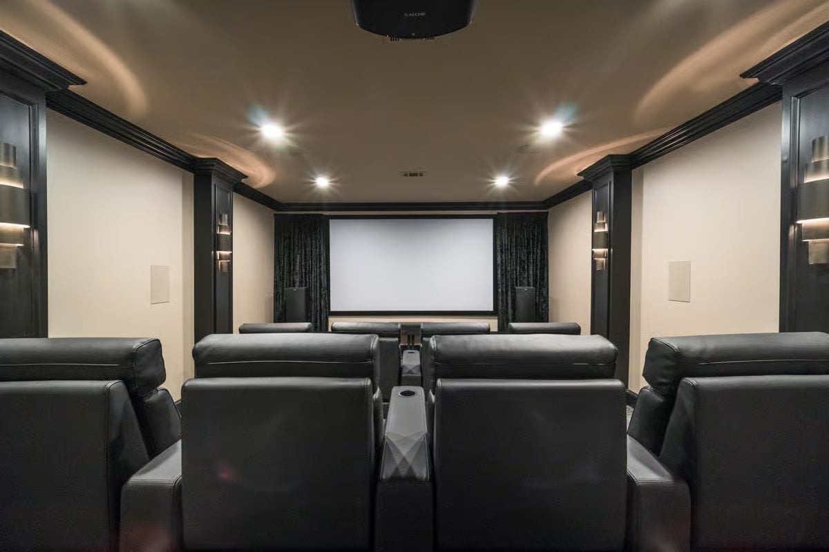 Leather Recliners, a Sony Projector, and Acoustic Panels Doing Real Work