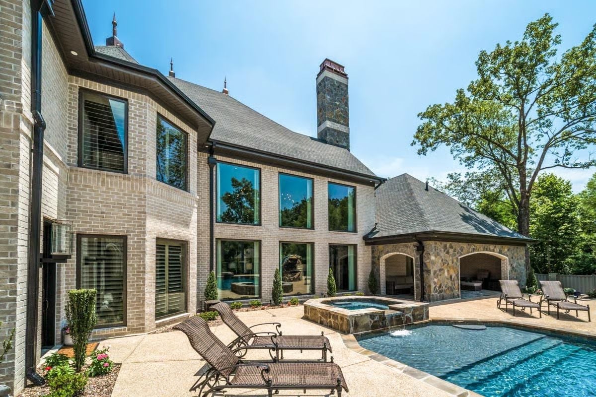 Limestone Brick, Mirrored Glass, and a Pool Pavilion Built to Last Decades