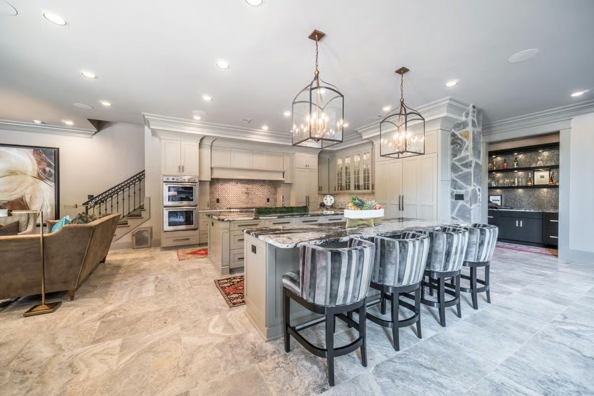 Marble Island, Stone Column, and Bar Alcove Pull Three Rooms Into One Kitchen