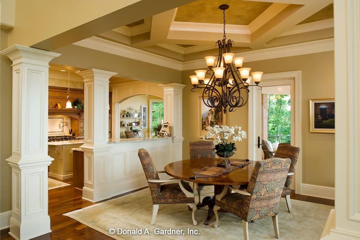 Coffered Ceiling and Wrought-Iron Chandelier Define the Dining Room's Character