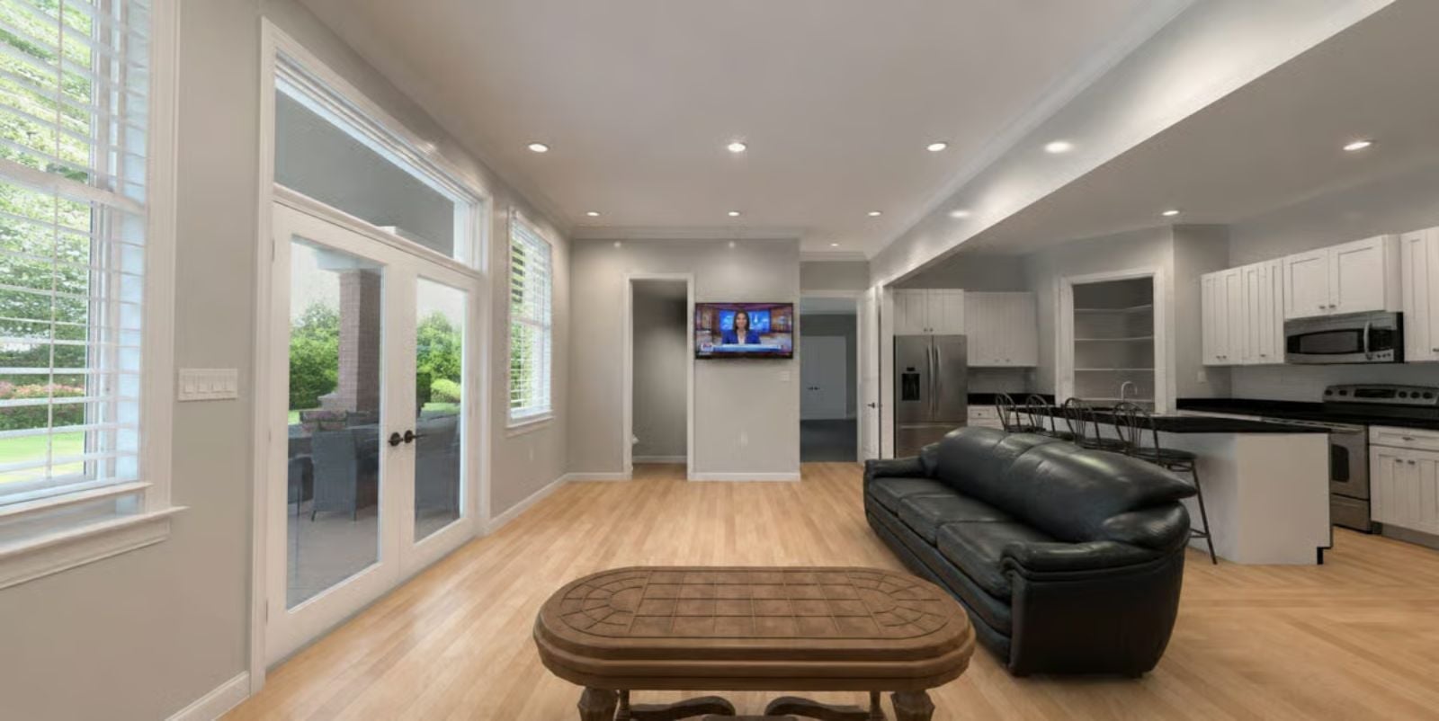 Leather, Light Wood, and French Doors That Pull the Outside In