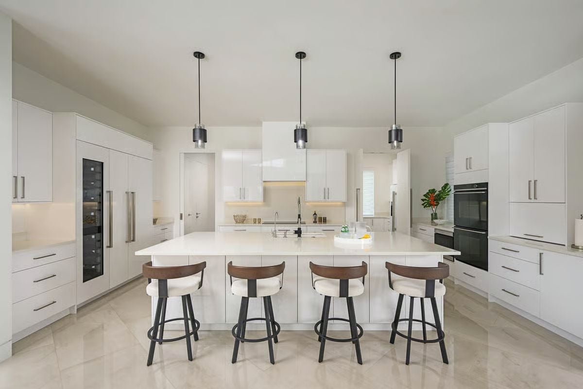 Four Bar Stools and Three Pendants Make the Island the Whole Point