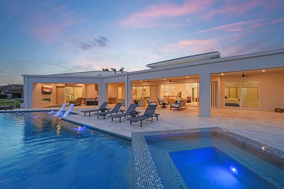 Infinity Edge at Dusk with a Spa, Water Feature, and Open-Air Living Behind It