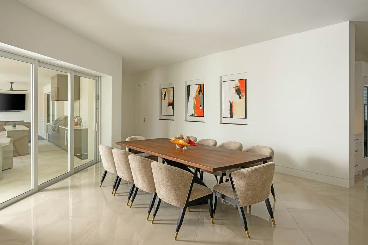 Walnut Dining Table for Ten with Gold-Tipped Chair Legs and Abstract Art Trio