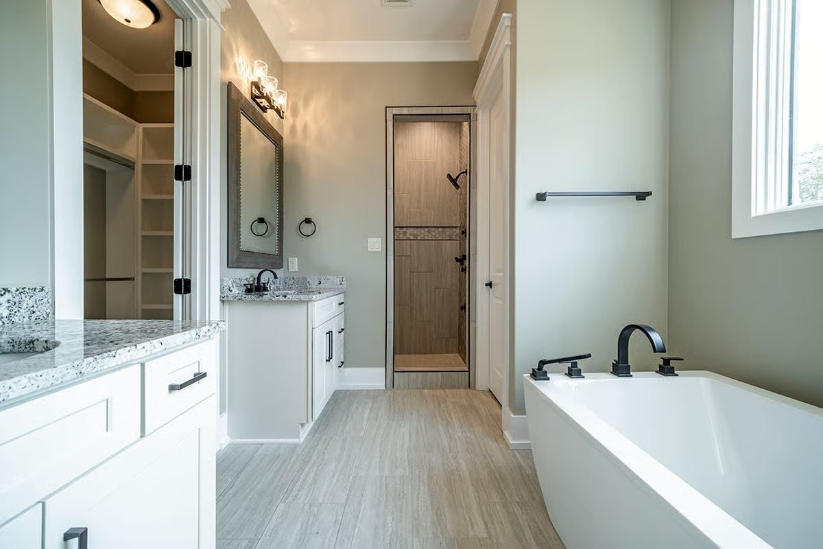 Matte Black Fixtures Against White Cabinets Pull This Master Bath Into Focus