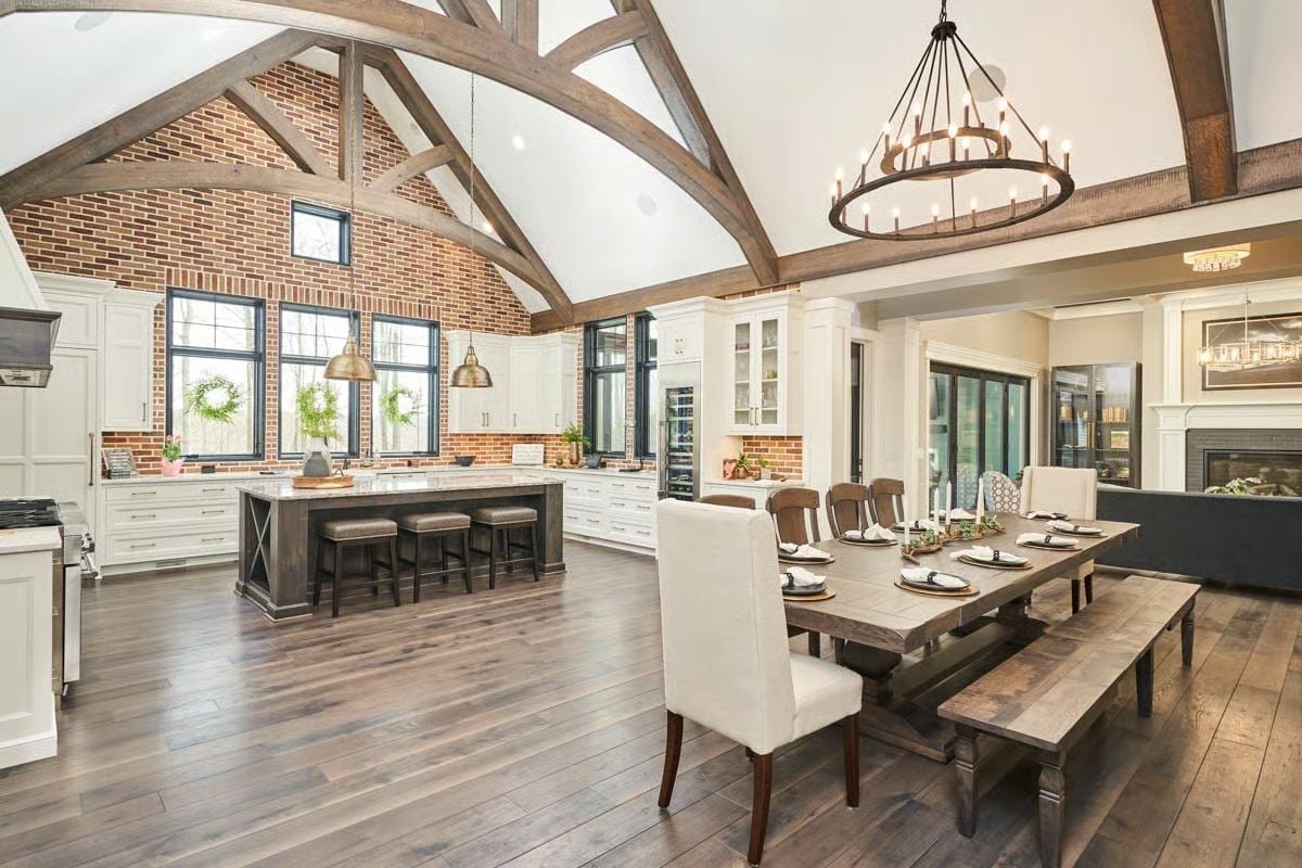 Exposed Brick Vault with Cathedral Trusses Opens the Kitchen to the Dining Room