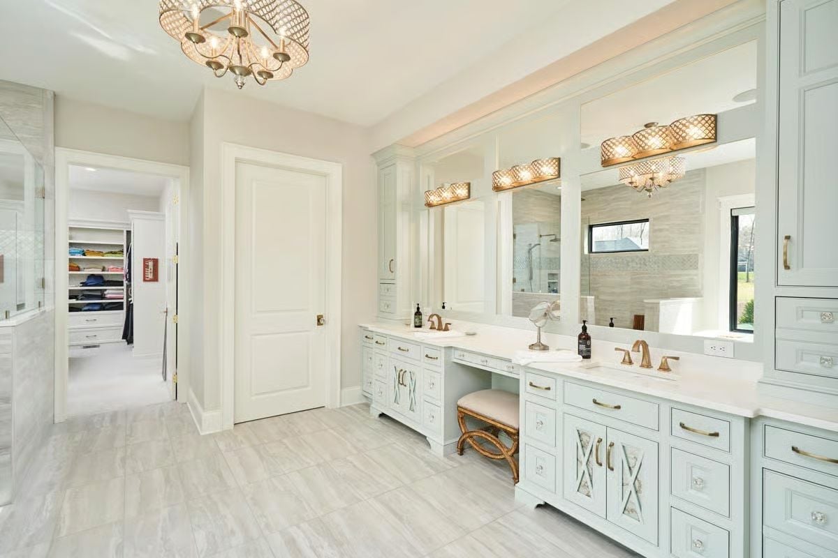 Mint Cabinetry and Brass Hardware Make the Double Vanity Worth the Square Footage