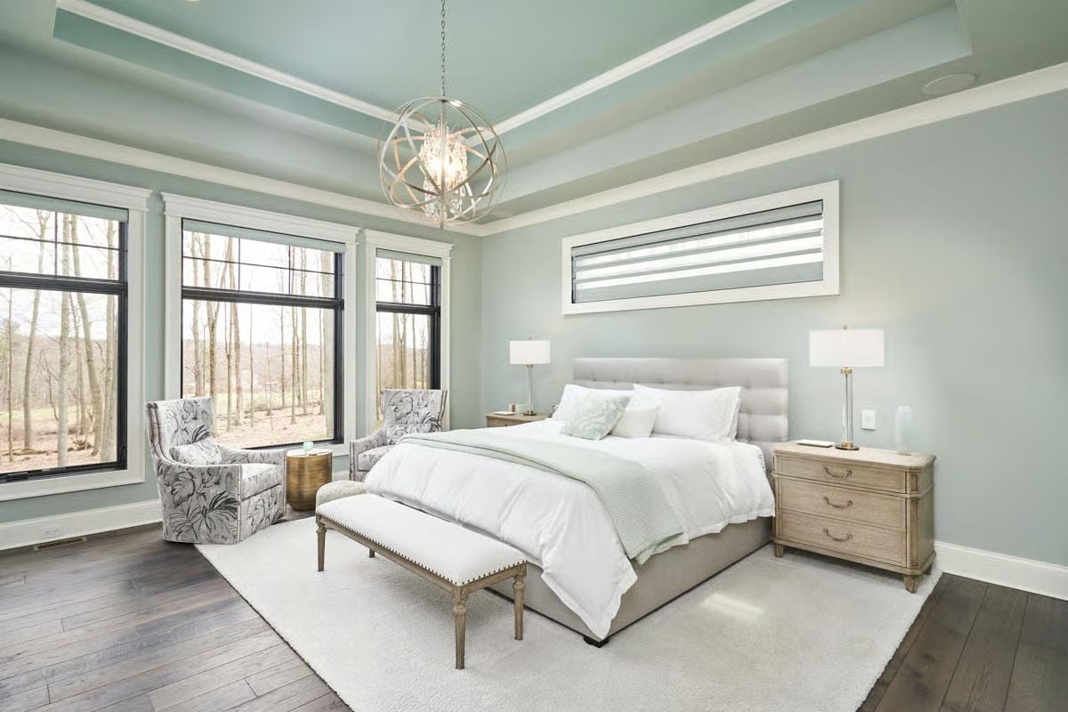 Soft Sage Walls and an Orb Chandelier Define the Primary Suite's Quiet Authority
