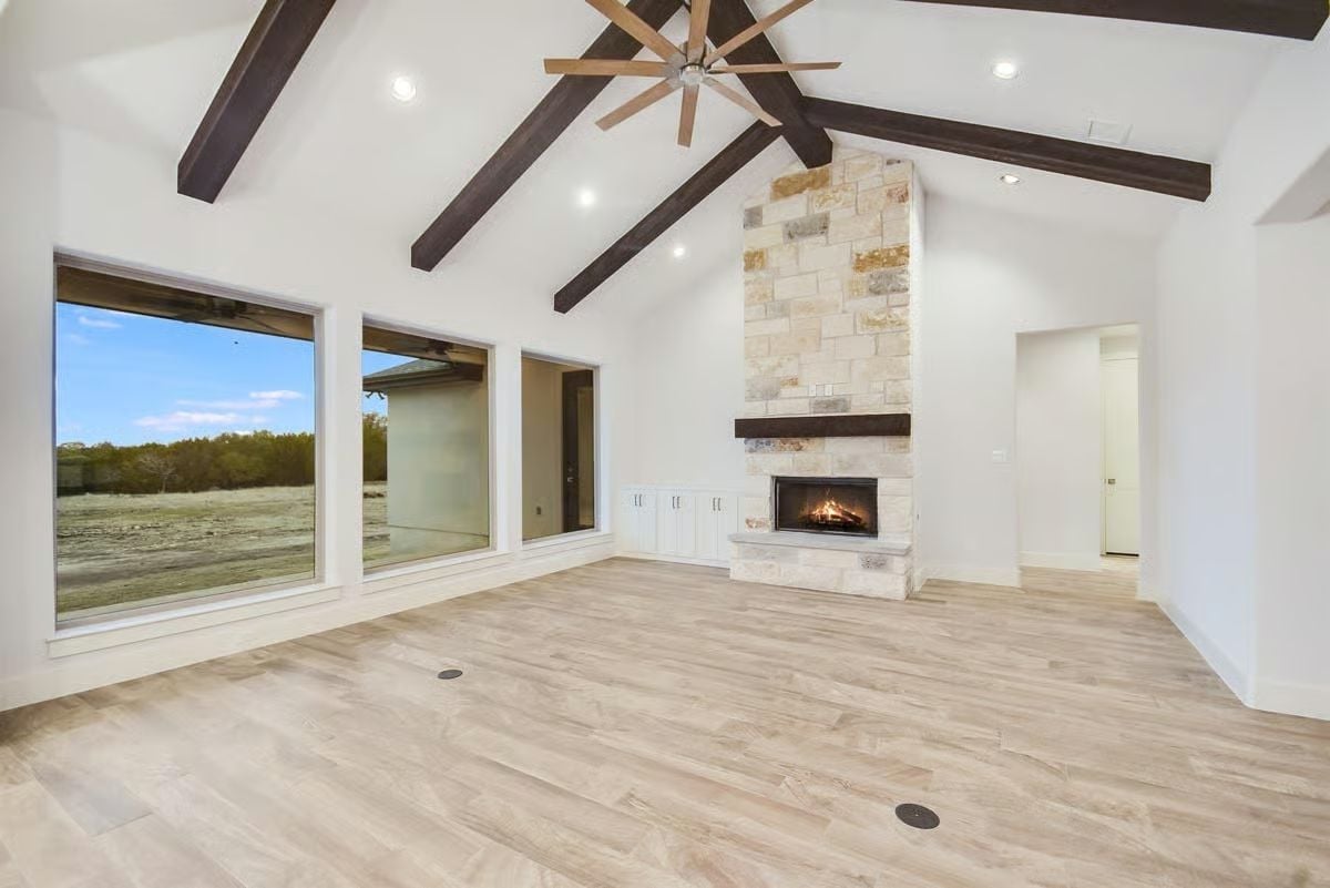 Vaulted Great Room Built Around a Floor-to-Ceiling Stone Fireplace