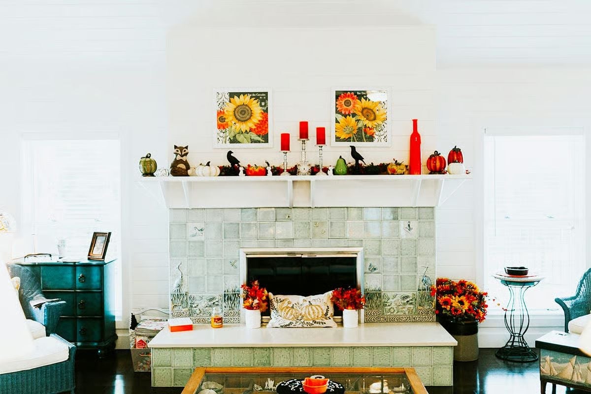 Crow Figurines, Red Candles, and a Mantel That Takes Fall Seriously