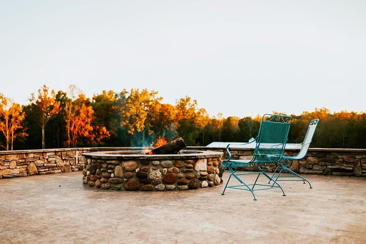 River Rock Fire Pit and Two Teal Chairs Built for Doing Absolutely Nothing