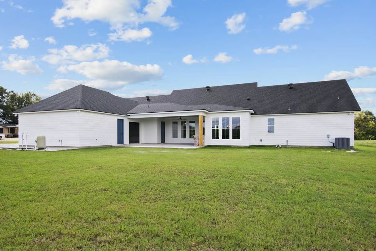 Crisp White Lap Siding and a Dark Roof That Keep a Big Footprint From Feeling Heavy