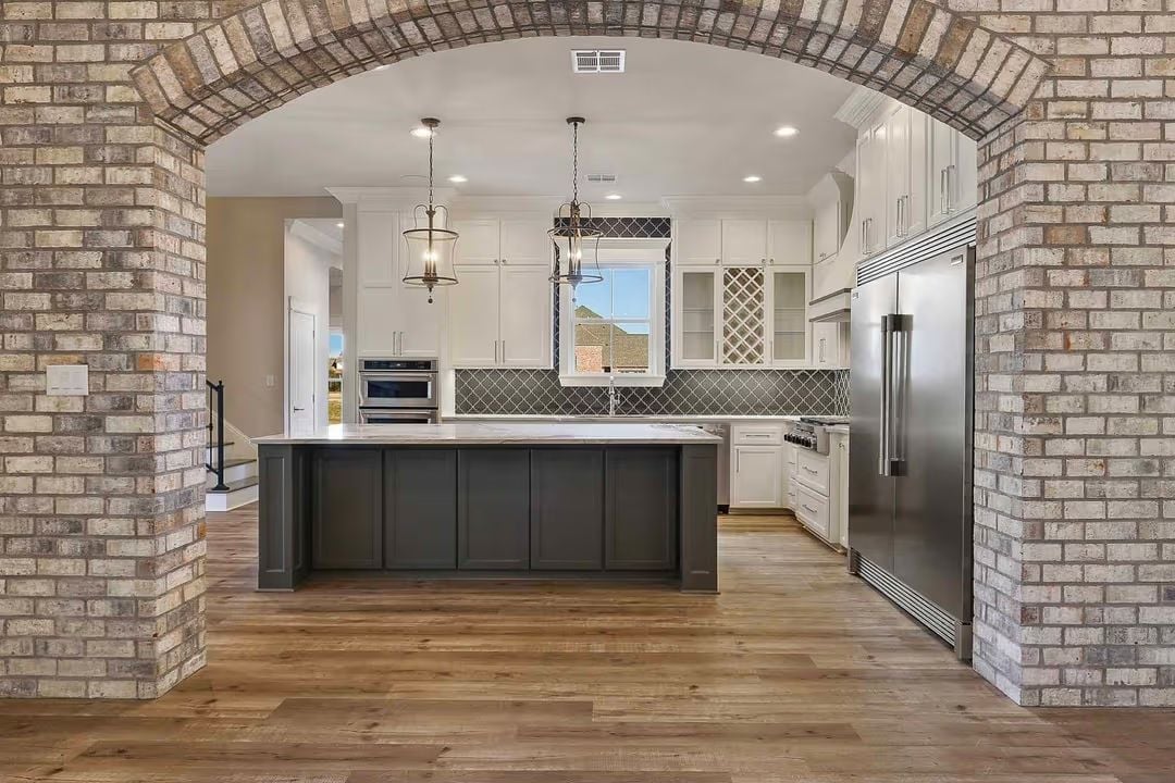 Brick Arch Entry Into a Kitchen That Knows How to Make an Entrance