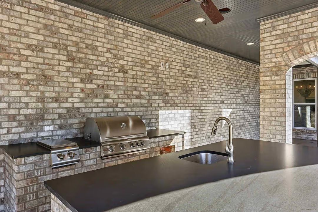 Covered Outdoor Kitchen With Brick Surround Built to Handle Real Cooking