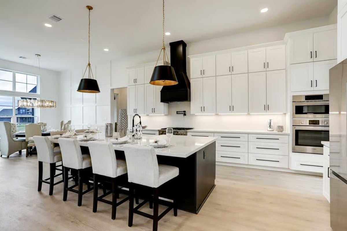 Black Island, White Cabinets, and a Range Hood That Means Business