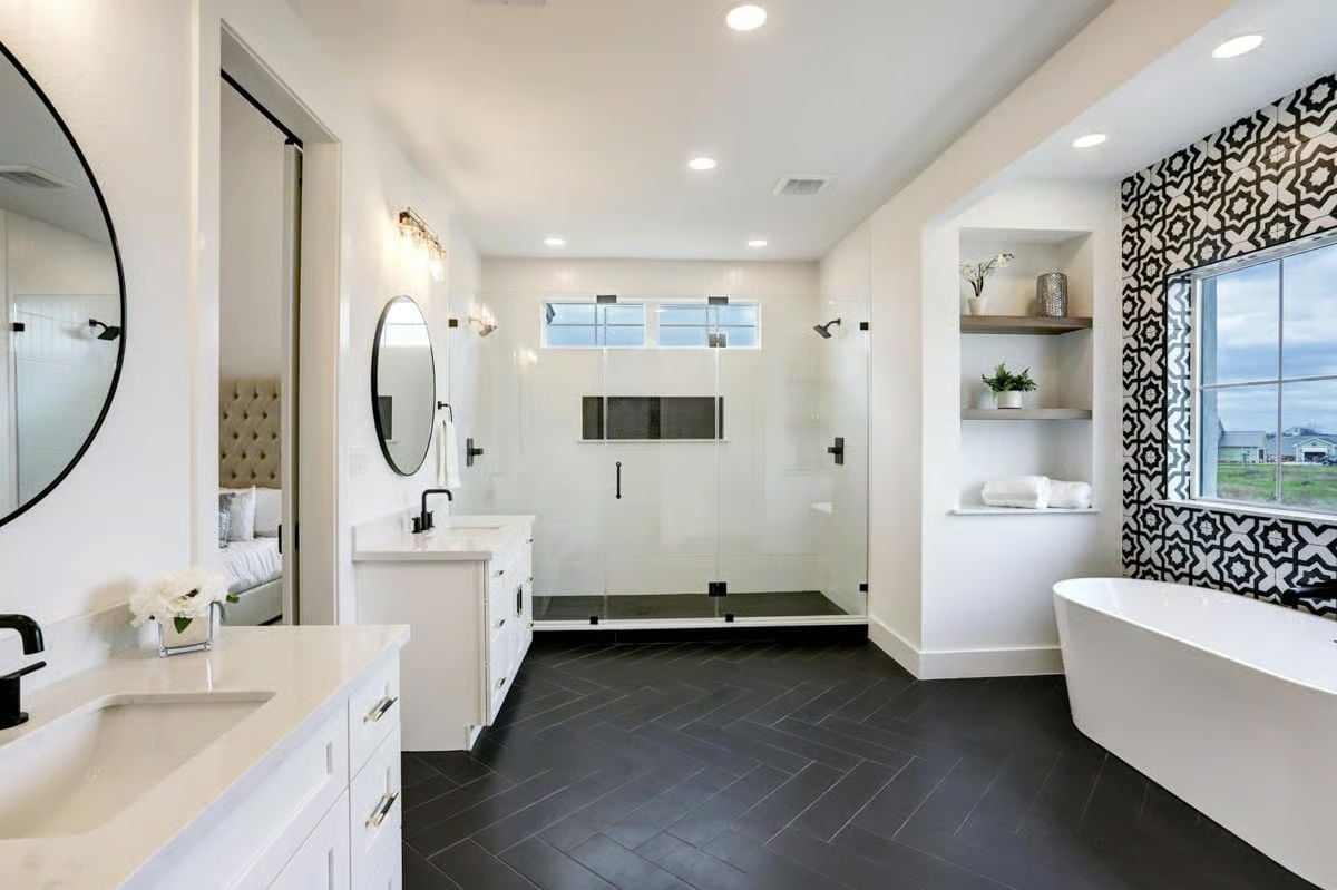 Herringbone Floor, Freestanding Tub, and a Tile Wall That Does the Talking