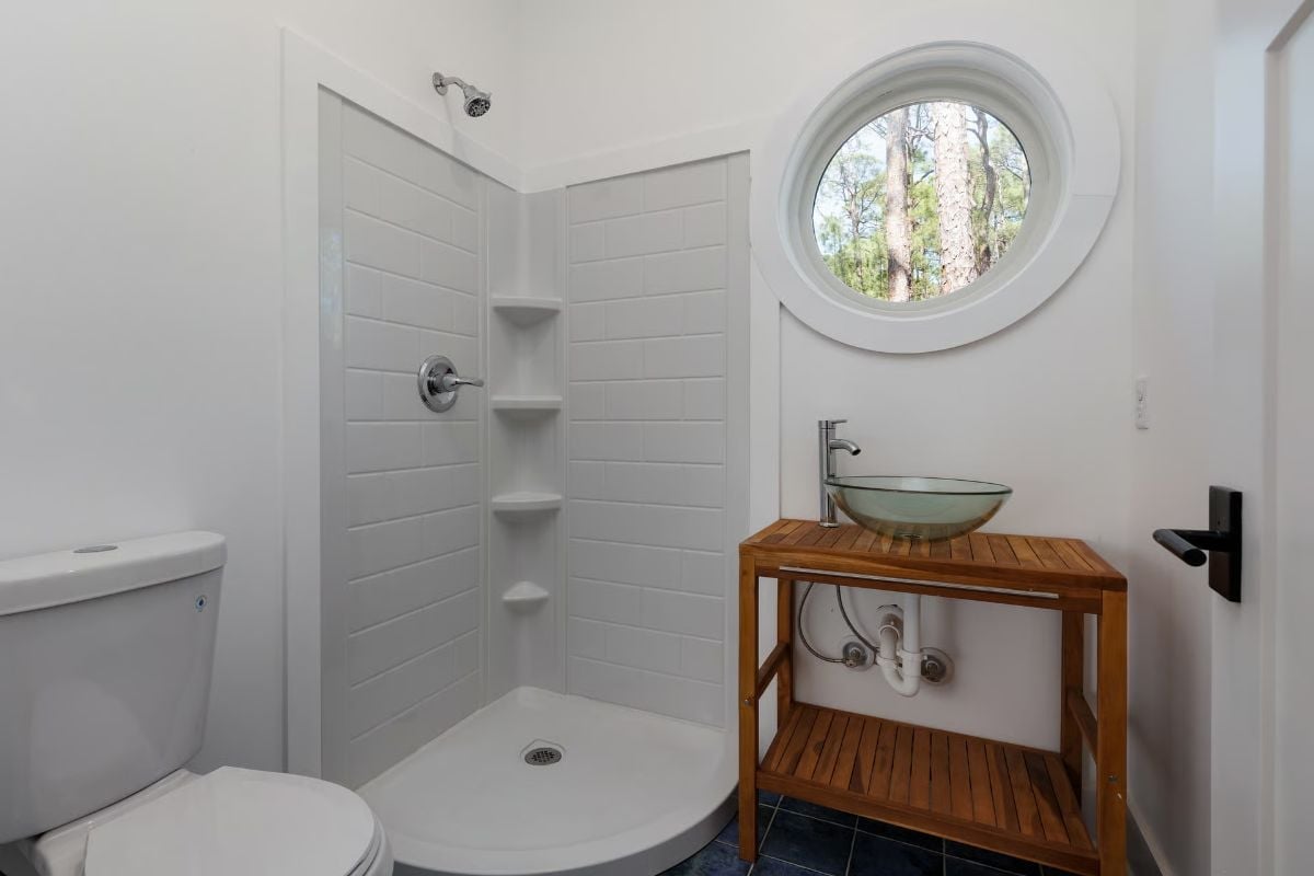 Round Porthole Window and a Glass Bowl Sink That Earn Their Keep