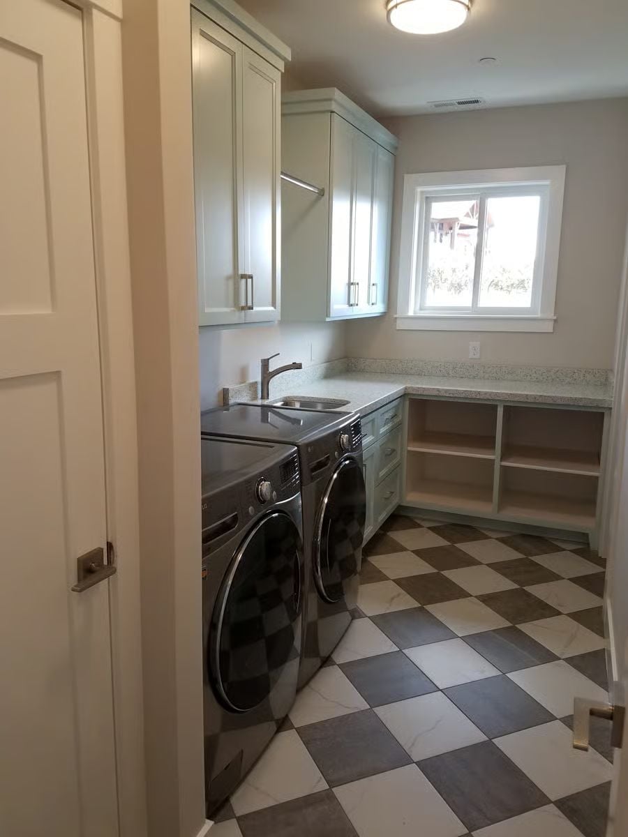 Checker Floor and Silver Machines Make This Laundry Room Refuse to Be Boring