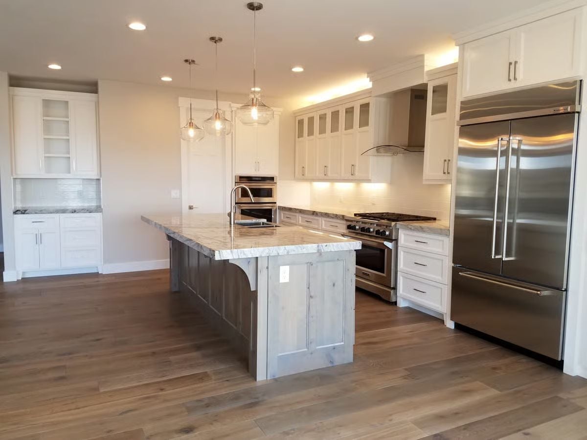 Driftwood Island Base Against White Cabinetry Is the Contrast That Holds the Room Together