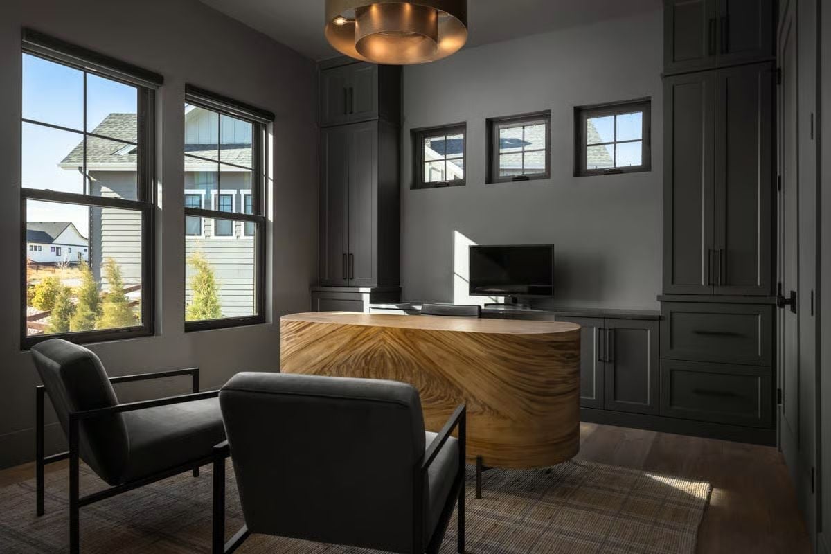 Oval Wood Desk Commands This Dark, Moody Home Office Like Nothing Else
