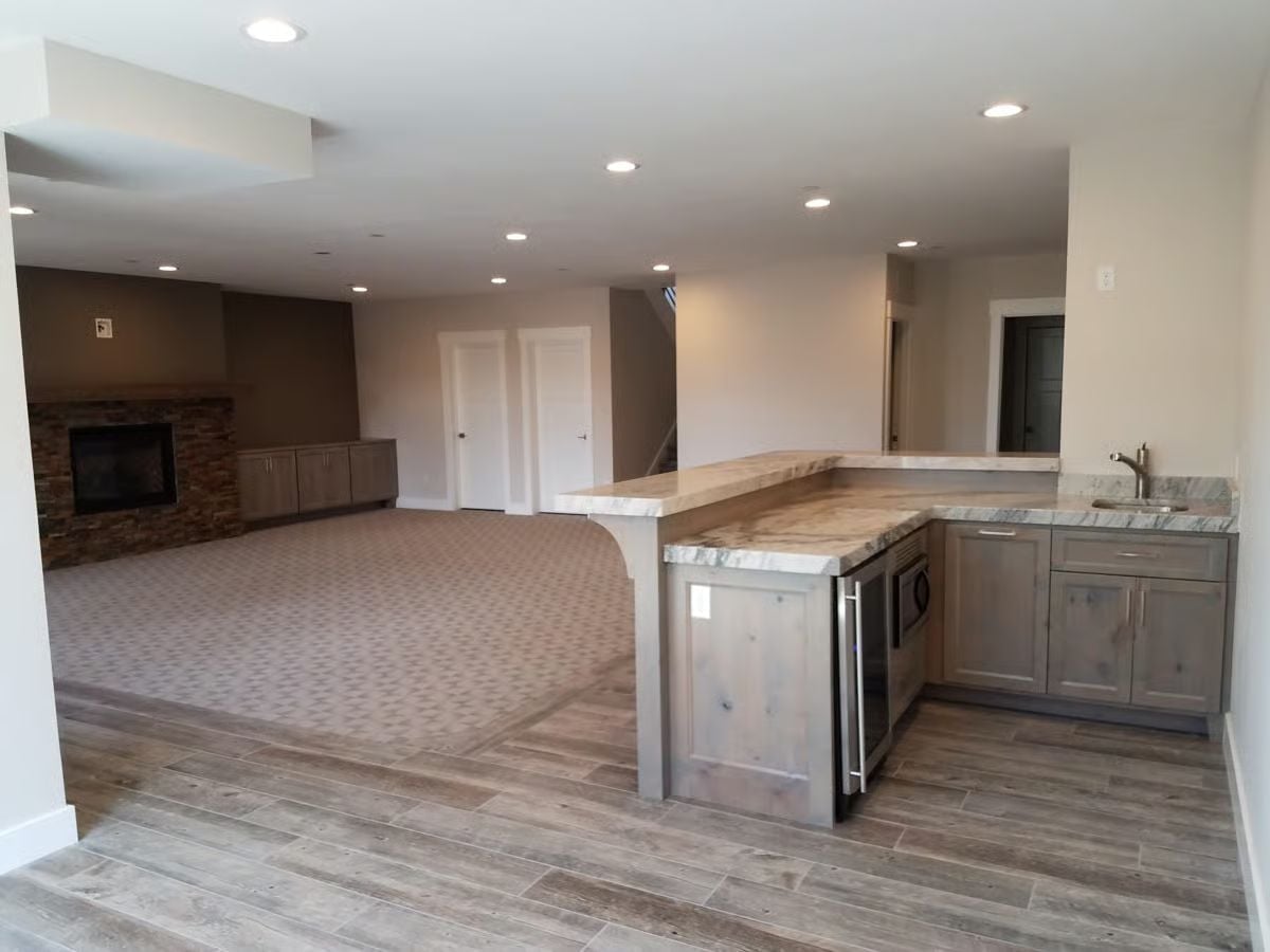 Wet Bar Peninsula With a Beverage Fridge Built for Guests Who Stay Too Long