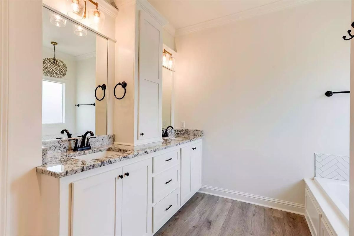 Black Hardware Against White Cabinetry Keeps This Double Vanity Honest