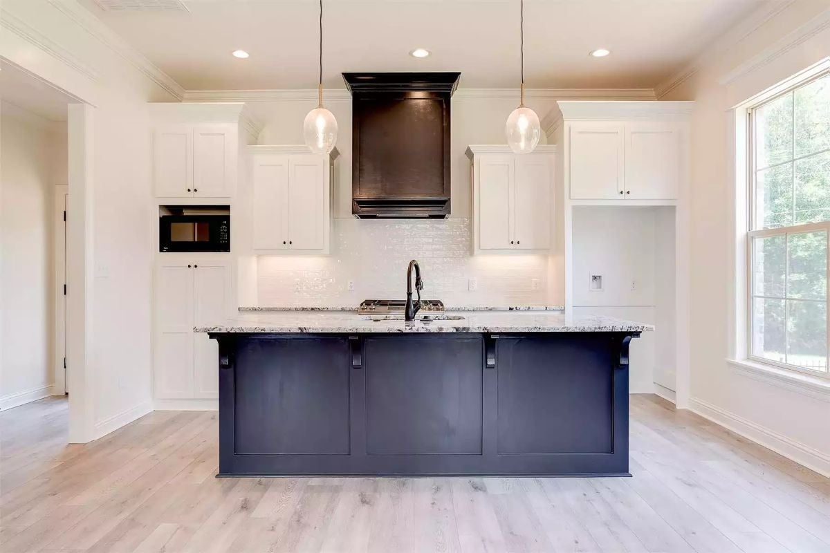Navy Island Base and Dark Range Hood Pull the White Kitchen Off Neutral