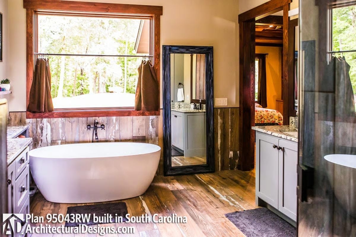 Freestanding Soaker Tub Positioned Under a Window Is the Move Every Master Bath Needs