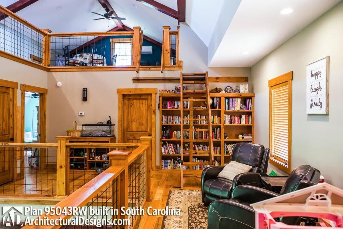 Loft Ladder, Wall of Books, and Leather Recliners Make This Loft Feel Earned