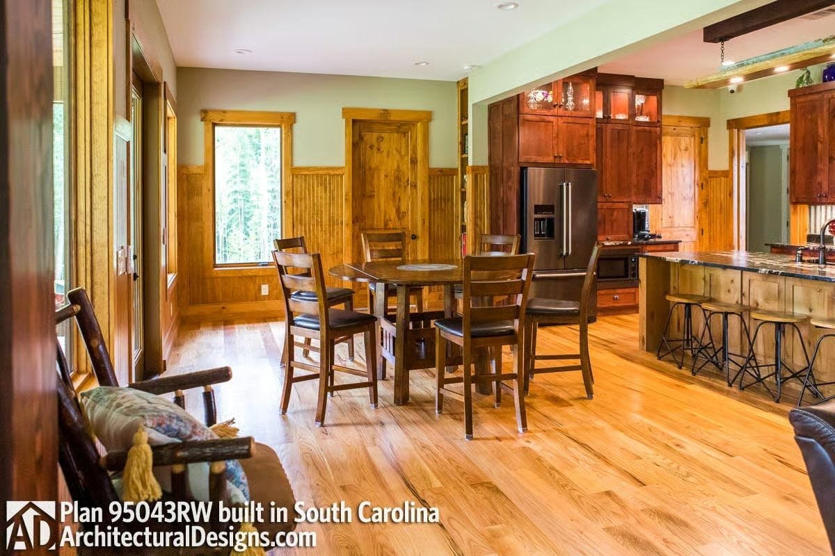Warm Wainscoting and Round Table Give This Dining Room a Cabin Lodge Feel