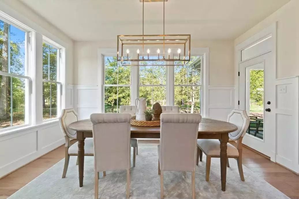 Gold-Frame Chandelier, Tufted Linen Chairs, and Windows That Do the Heavy Lifting