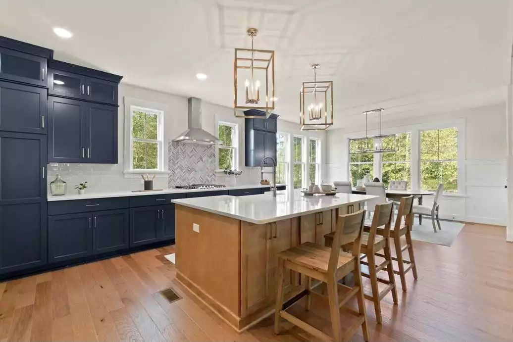 Navy Cabinets, a Wood Island, and Pendant Lights That Know Their Scale