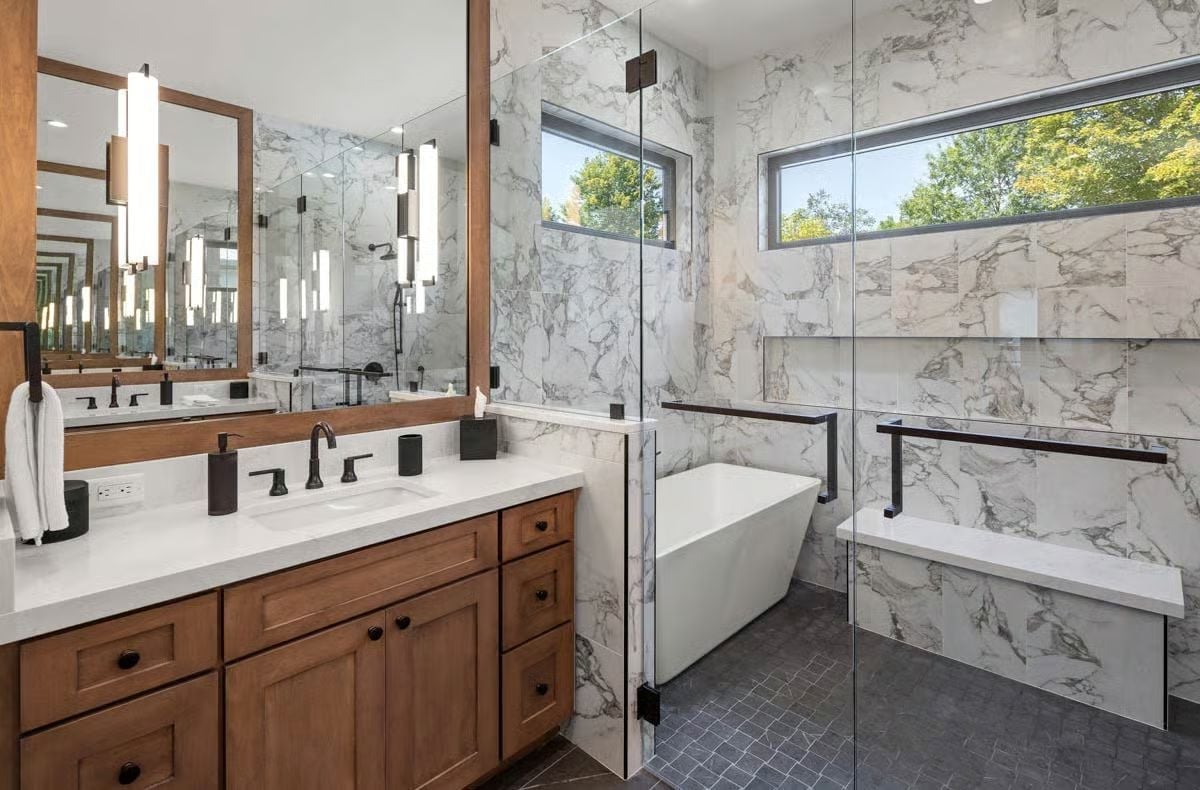 Marble Walls, Warm Wood, and a Freestanding Tub That Earns Every Square Foot