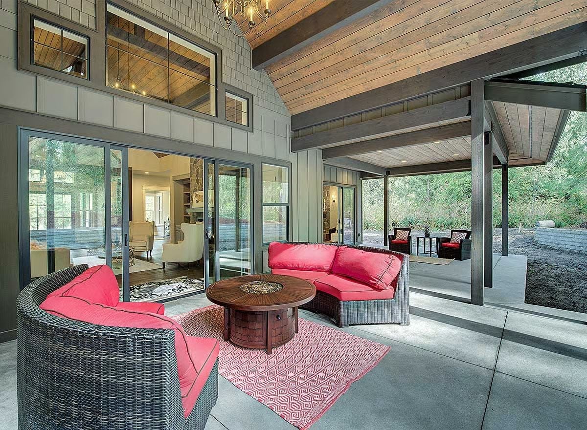 Pink Cushions and a Fire Pit Table Turn This Covered Patio Into an Outdoor Living Room