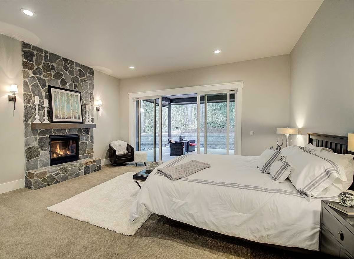 Stone Fireplace, Sliding Glass Walls, and a Bedroom That Earns Its Square Footage