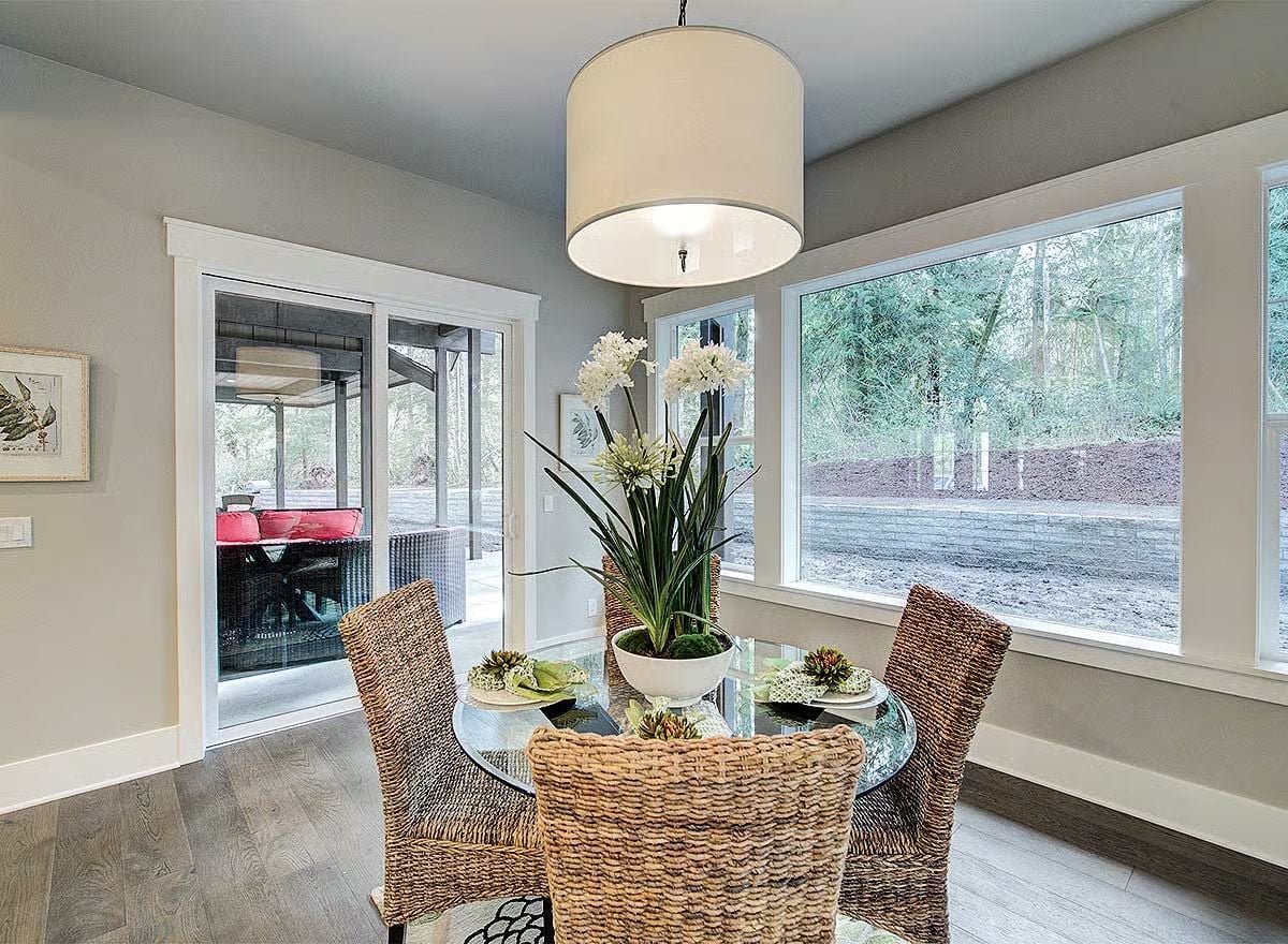 Wicker Chairs and a Glass Table Keep This Dining Room from Taking Itself Too Seriously