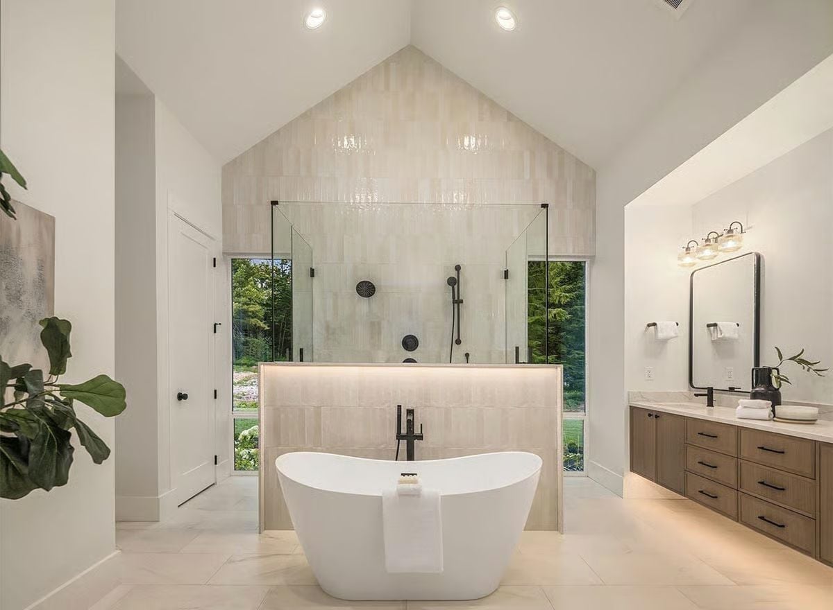 Soaking Tub Centered on a Tiled Wall That Goes All the Way to the Vaulted Peak