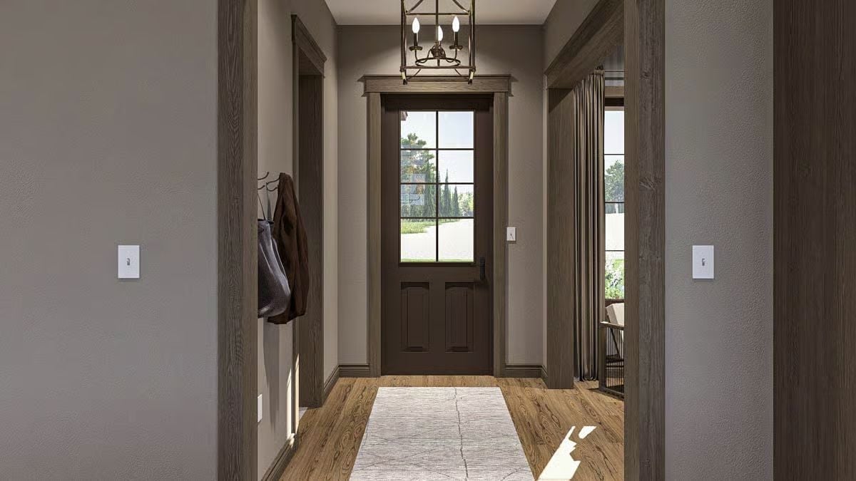 Warm Wood Trim and a Candle-Style Chandelier Set the Tone at the Front Door
