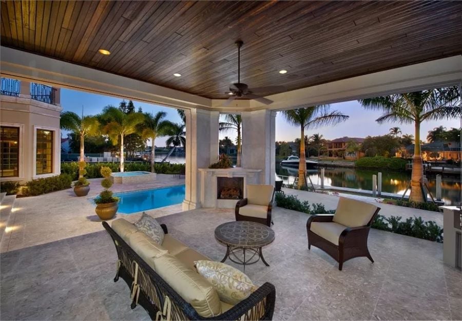 Covered Lanai with a Waterway View and a Fireplace Nobody Expected Outdoors