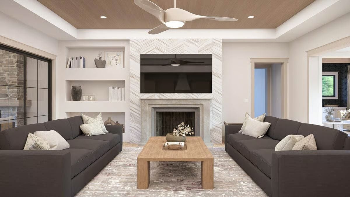 Herringbone Stone, Dark Sofas, and a Fireplace Wall That Pulls It All Together
