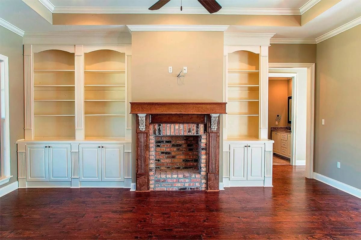 Built-Ins Flanking a Brick Fireplace With a Wood Mantel Worth Noticing