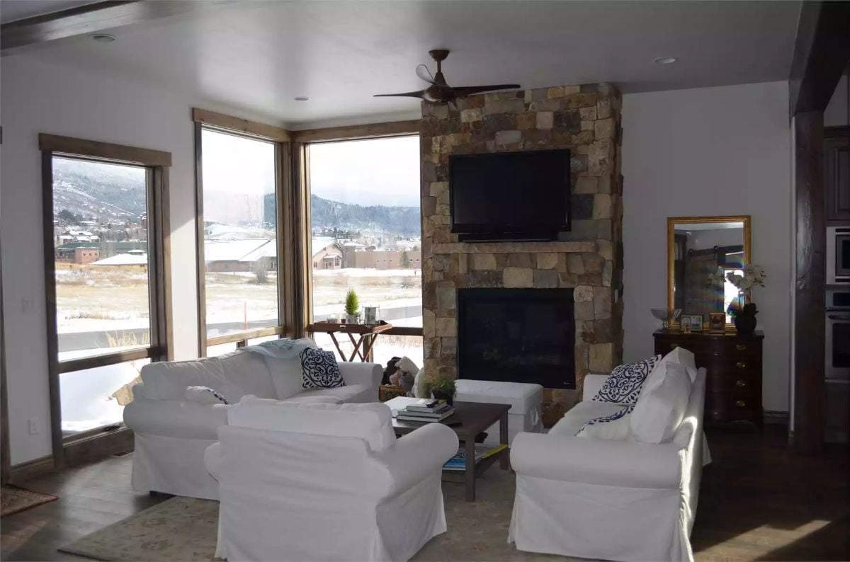 Stone Corner Fireplace Commands the Room Without Competing With the View