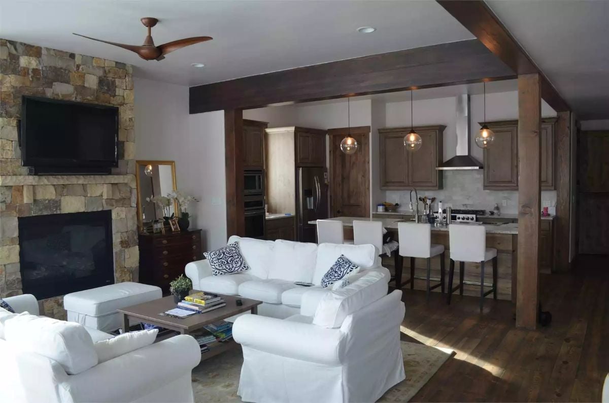 Stone Fireplace Wall and White Slipcovers Set the Tone for This Open Living Space
