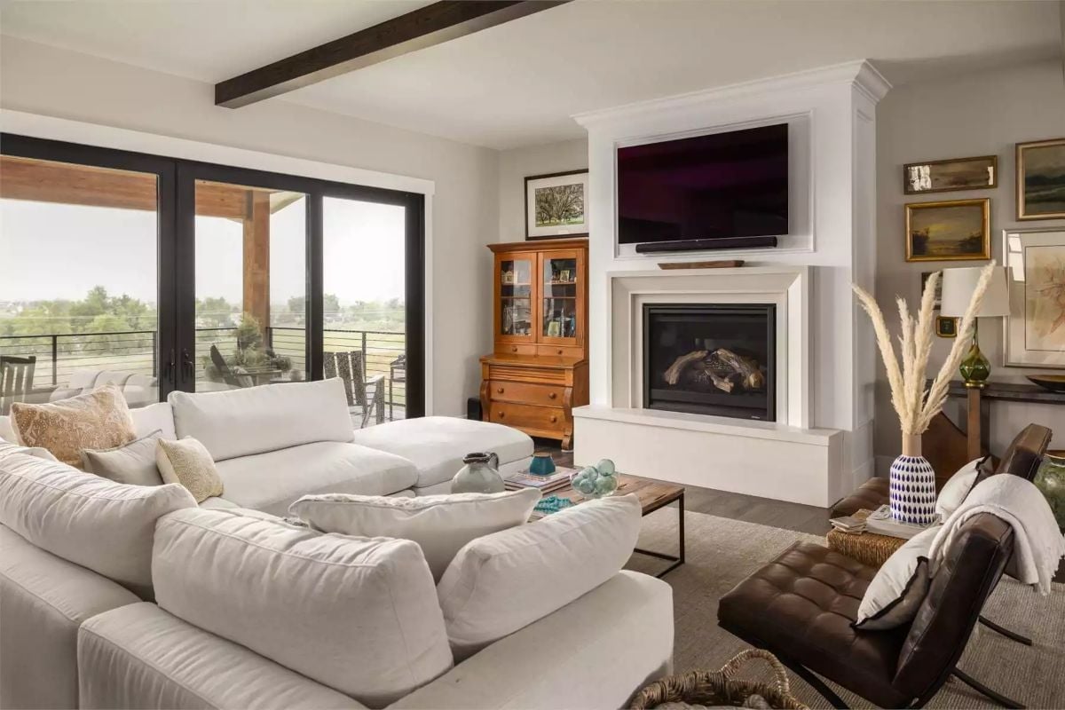 Cream Sectional, Wood Beam, and a Fireplace That Actually Gets Used