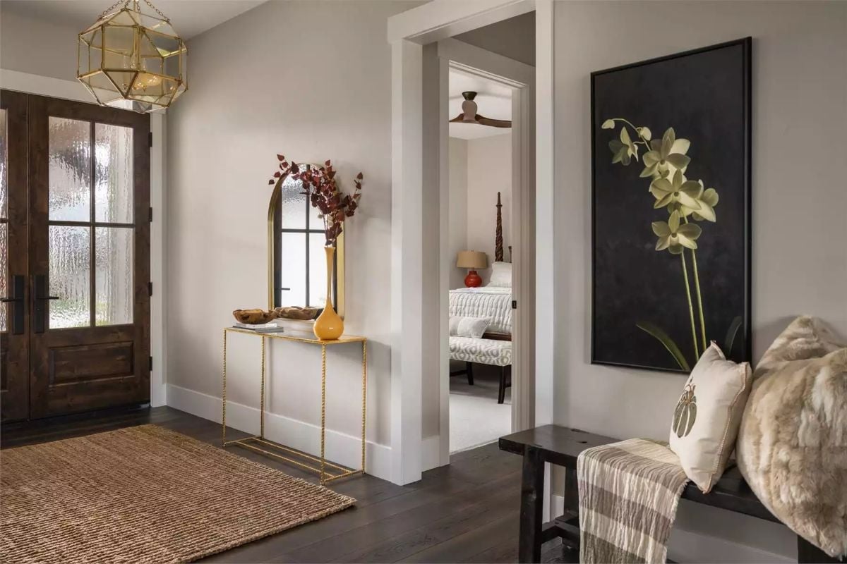Gold Console, Dark Wood Door, and an Orchid Painting That Anchors Everything