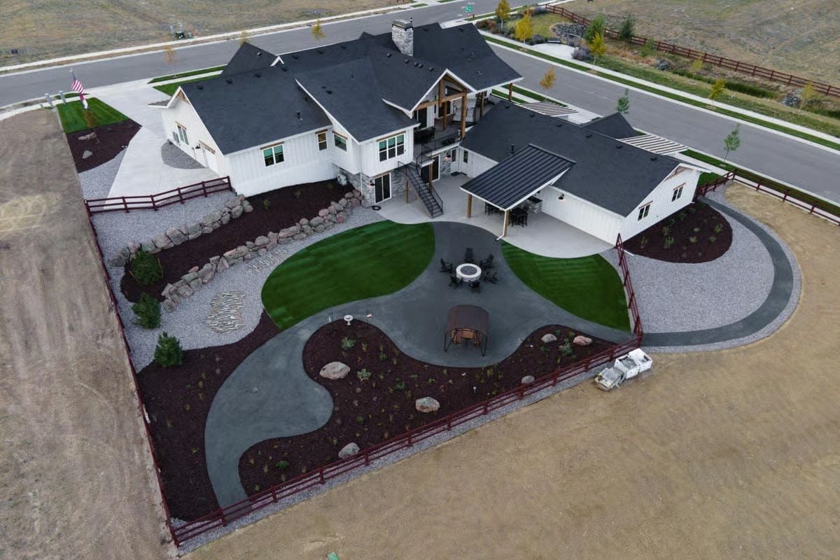 Curved Concrete Paths and Dark Mulch Beds Doing the Heavy Lifting Outside