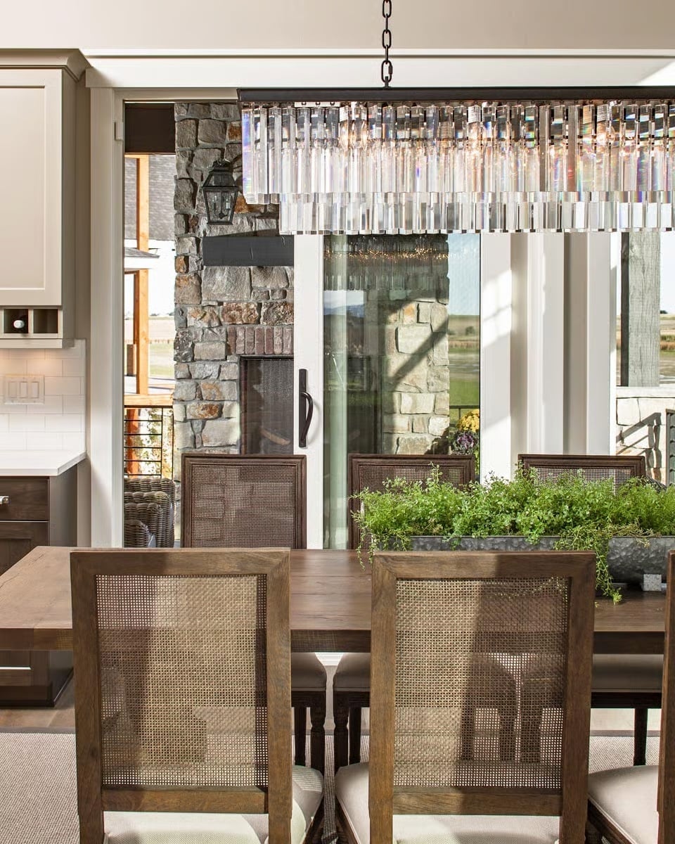 Crystal Chandelier Over Cane-Back Chairs Earns Every Inch of That Contrast