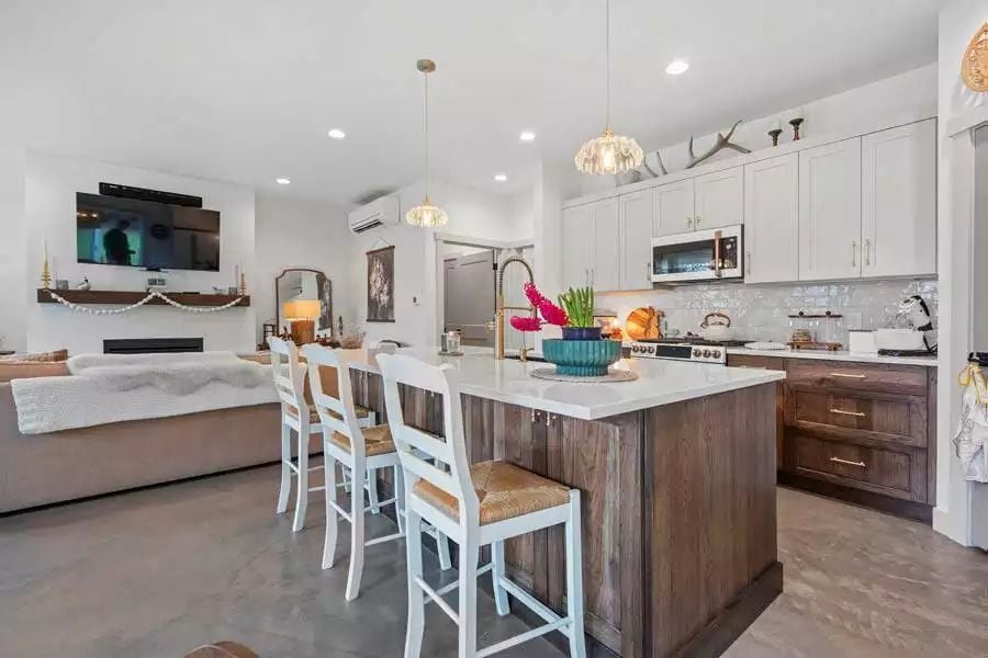 Concrete Floors, Warm Wood, and a Kitchen Island That Pulls Everything Together
